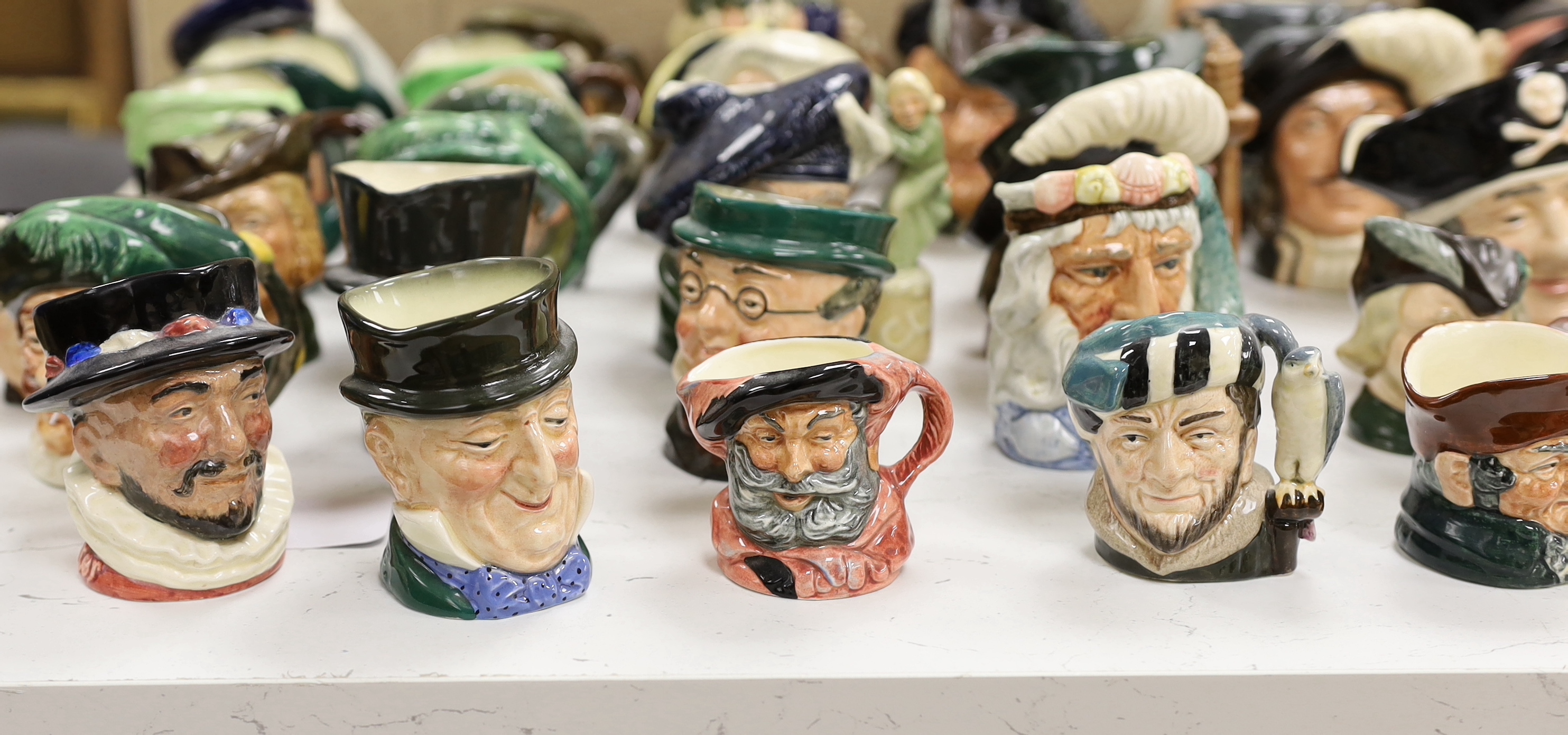 A large collection of Doulton character jugs including the Three Musketeers and Bacchus, largest 10cm high